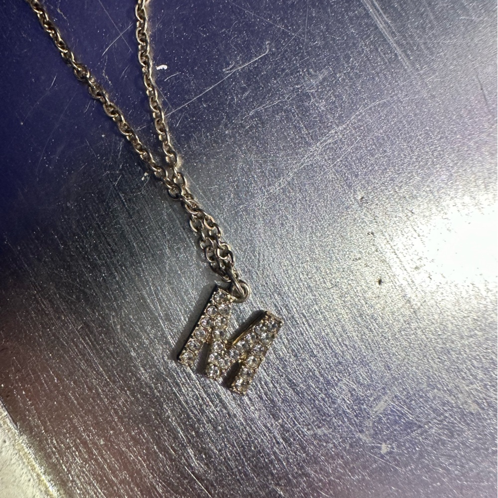 Gold “m” necklace